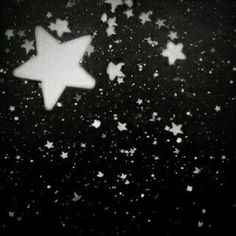 the stars are falling down on the black background