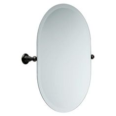 an oval mirror mounted on the wall with a black metal arm and round glass frame