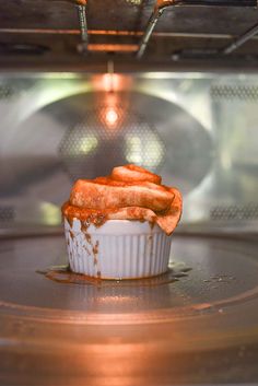 a cupcake sitting in the middle of an oven