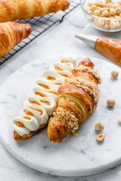 croissants on a plate with almonds and other food items