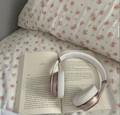 an open book with headphones on top of it