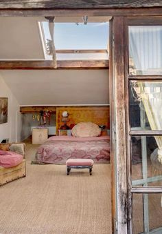 a bedroom with a bed, chair and window looking out onto the outside patio area