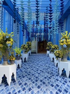 a blue and white room with potted plants in it