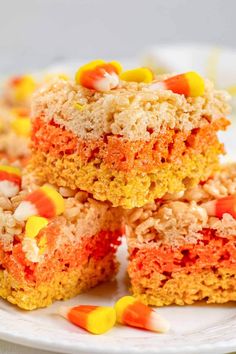 several pieces of cake on a white plate with candy corn and marshmallows