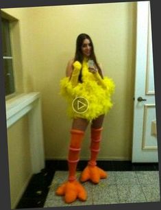 a woman dressed in yellow and orange is taking a selfie with her cell phone