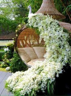 an outdoor seating area with white flowers on it