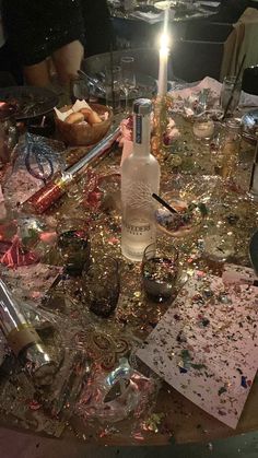 the table is covered with confetti, candles and other items that have been left on it