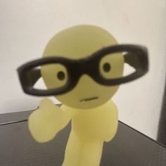 a small yellow figure with glasses on it's face