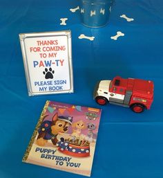 there is a birthday card and toy truck on the table