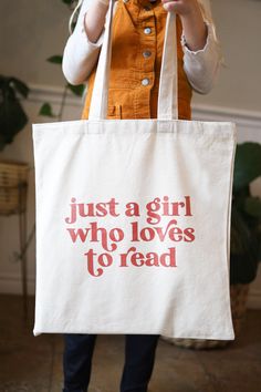 Are you a girl who loves to read? Need a sturdy tote bag? This one is perfect for library days, beach days, and everything in between! A natural cotton canvas bag with reinforced handles, this bag is perfect for girls of all ages. Dimensions: 15"W x 16"H with 20" handles (9" handle drop) Bookish Cotton Tote Bag, Cotton Tote Bag With Bookish Style, Bookish Tote Bag, Mobile Bookstore, Cute Tote Bag Design, Tote Bag Quotes, Tote Bag Design Ideas, Tote Bad, Creative Tote Bag