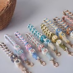 a bunch of different colored key chains next to a basket