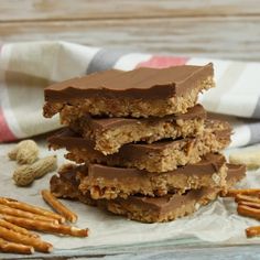 chocolate and pretzel bars stacked on top of each other with some pretzels next to them