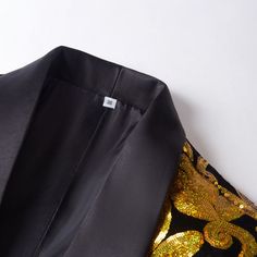 Product Detail Material: 80% Polyester 20% Viscose Design One Button & Shawl Collar Package 1*Jacket Occasion Wedding / Prom / Homecoming / Dinner / Red Carpet / Party The black tuxedo with gold sequin floral embroidery and shawl collar is a symbol of opulence and refined fashion. This tuxedo is meticulously constructed to make a statement, with intricate gold floral embroidery on a sleek black background and a traditional shawl collar.This black tuxedo is ideal for nuptials, galas, or any other Homecoming Dinner, Embroidery Shawl, Luxurious Wardrobe, Shawl Collar Tuxedo, Button Shawl, Red Carpet Party, Refined Fashion, Gold Jacket, Black Tuxedo