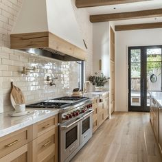 a kitchen with an oven, stove and wooden cabinets in it's center island