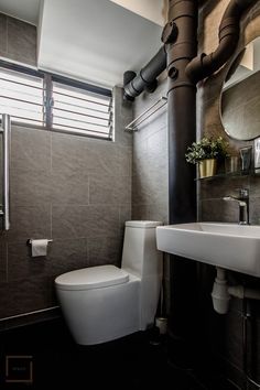 a white toilet sitting next to a bathroom sink