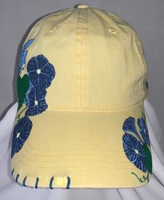 "Good Morning, Glory" women's adjustable ball cap shown in yellow. This baseball cap features beautiful clusters of morning glories that have been wood burned, and then precision dyed and painted by hand. The unique stitching and handmade charm make this cap a must-have for all the morning people out there. Available in yellow (shown), lavender, pink and white. Please note that charms may vary from what is shown depending on supply. ALL designs are fully customizable; Personal color options may be made-to-order. Custom orders can take up to two weeks to create.  Email SouthernSunshineCustoms@gmail.com with any questions, or to discuss custom order options.  Return Policy We will accept returns of item if notified within 14 days. Buyer to pay all costs associated with return shipping. Funds Yellow Summer Visor Baseball Cap, Yellow Visor Baseball Cap For Summer, Yellow Cotton Trucker Hat With Curved Brim, Yellow Baseball Cap For Spring, Yellow Baseball Cap With Curved Brim, Yellow Snapback Dad Hat For Spring, Yellow Dad Hat For Summer, Yellow Dad Hat Baseball Cap For Summer, Yellow Curved Brim Baseball Cap For Summer