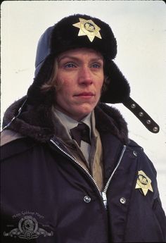 a woman wearing a police hat and coat