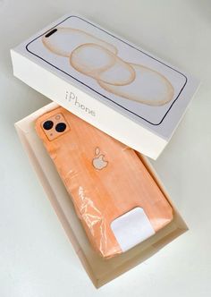 an apple phone in its box with the case open