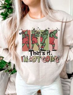 "Sweatshirt Details: // This listing includes One sweatshirt or short sleeve tshirt // Cotton & Polyester Blend - extra soft feel // Fleece lined, light weight, but warm // Graphic shows a green christmas character stomping and a quote that says \"That's it I'm not going\" // These are Unisex sized shirts // Plus Size Available TURNAROUND TIME: // Roughly 5 days + shipping (due to holiday volume the closer to Christmas, the longer the turnaround will be) // If you need this item by a particular Holiday Tees, Funny Christmas Sweater, Sweatshirt Details, Funny Christmas Sweaters, Popular Shirt, Christmas Sublimation, Png Christmas, Christmas Png, Green Christmas