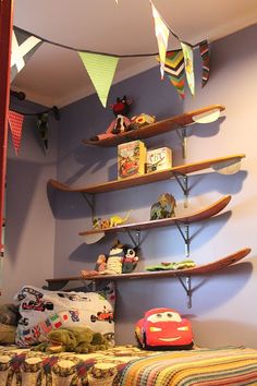 a child's bedroom with shelves and toys on the wall