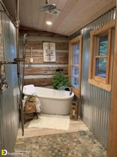 a bathroom with a bathtub, toilet and window in it's side wall