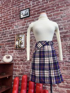 "70s Plaid Purple Mini Skirt Gorgeous '70s ultra mod plaid mini skirt. Fantastic waistline detail with a swooping yoke that finishes off with a 3 button closure. The perfect A line cut with wide pleats on the left side. The fabric is 100% acrylic. The print has the most beautiful shades of purple, peanut butter, ivory and black that intertwine into a stunning plaid. Fabric is backed with a synthetic. In excellent vintage condition. Measurements: 26.5\" waist 40\" hip 19\" length No returns or ex Purple Mini Skirt, 70s Plaid, Vintage Instagram, A Line Cut, Womens Skirts, Plaid Mini Skirt, Plaid Fabric, Shades Of Purple, Peanut Butter