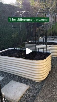 an outdoor garden with raised planters in the middle and a sign that says the difference between