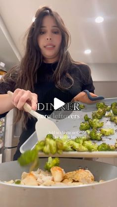 a woman is cooking broccoli in a pan