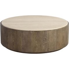 a round wooden table sitting on top of a white floor