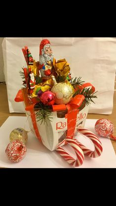 a basket filled with candy canes and candies on top of a white table