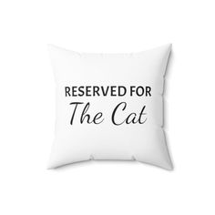 a white pillow that says reserved for the cat