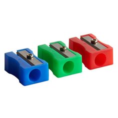 four different colored plastic blocks with metal clips