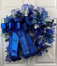 a blue and white wreath hanging on the front door