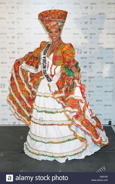 a woman dressed in traditional mexican clothing posing for the camera with her hands on her hips