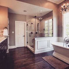 a large bathroom with a tub, sink and shower