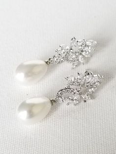 "Pearl Wedding Earrings Lovely classic pearl drop earrings for the bride. Cubic zirconias set in a silver setting with a light cream faux pearl. Very light weight and easy to wear with posts for pierced ears only. Also available in rose gold color at this time. ♥ DETAILS: Pearl Drops, Cubic Zirconia stones ♥ SIZE: Earrings measure 1 3/8\" in length ♥ COLOR: Silver or Rose Gold finish with light cream pearls (Only 1 pair of rose gold left) ♥PRODUCTION TIME: Ready to ship ♥ Please be sure to read Classic Pearl Earrings With Cubic Zirconia For Party, Classic Silver Bridal Earrings For Formal Occasions, Classic Cubic Zirconia Pearl Earrings For Party, Elegant Cubic Zirconia Diamond Earrings With Pearl Drop, Formal Bridal Earrings With Pearl Drop And Cubic Zirconia, Formal Pearl Drop Bridal Earrings With Cubic Zirconia, Pearl Bridal Earrings In Diamond White For Anniversary, Formal Pearl Drop Bridal Earrings In Cubic Zirconia, Cubic Zirconia Pearl Drop Bridal Earrings For Formal Occasions