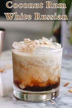 a close up of a drink on a table with the words coconut rum white russian