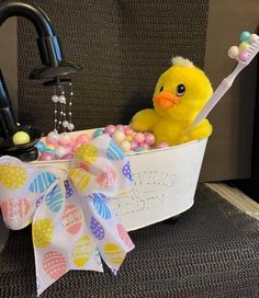 a yellow ducky in a bathtub filled with candy