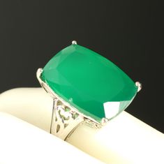 Vintage Green Chalcedony Ring Dyed Green Rectangle Gemstone Huge Statement Ring Sterling Silver Size 7 Lovely rectangular faceted chalcedony gemstone is prong set in a scrolled gallery sterling silver ring mounting.  Quite a statement ring! The chalcedony gemstone is dyed green.  Hallmarked on the interior of the shank 925, and the maker's initials GIE.    Condition: Previously owned, the gemstone does have one flea bite chip in the stone half way down on the girdle as seen in photos (maker's initial hallmark side).  Approximate Measurements: Ring Size 7.  Stone Size 14 x 20 mm. Back of Shank 3 mm. Thank you for visiting Clara's Chic Boutique! More vintage jewelry: https://www.etsy.com/shop/ClarasChicBoutique?ref=seller-platform-mcna0v§ion_id=13953588 Vintage Jewelry, Vintage Ring, Stateme Photo Maker, Silver Gift Wrap, Chalcedony Ring, Green Chalcedony, Ring Mountings, Silver Gifts, Vintage Ring, Jewelry Vintage, Ring Sterling Silver