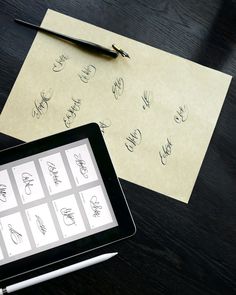 a tablet computer sitting on top of a wooden table next to paper with writing on it