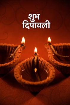 happy diwali greeting card with three lit candles in the shape of a bowl