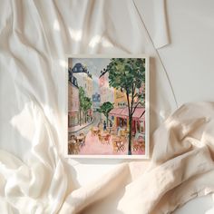 an image of a painting that is on the wall above a bed with white sheets