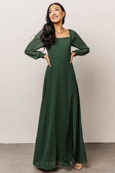 Rich evergreen color High-quality chiffon material Smocked back bodice Airy sleeves with smocked cuffs Slit at front left up to mid-thigh Fully lined excluding sleeves 100% Polyester Jing is 5'8, cup size 32A, size 0 and wearing size S Winter Bridesmaids, Winter Bridesmaid Dresses, Long Sleeve Bridesmaid Dress, Long Green Dress, Bridesmaid Dresses With Sleeves, Baltic Born, Modest Bridesmaid Dresses, Green Bridesmaid Dresses, Rust Dress