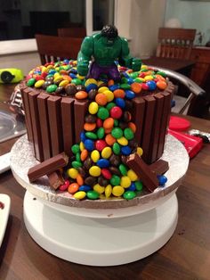 there is a cake made to look like a lego man in the middle of candy