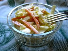 a salad with carrots and lettuce in a glass bowl