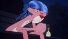 a cartoon character sitting next to a bottle