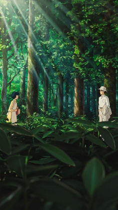 two people standing in the middle of a forest with sun shining through trees and leaves