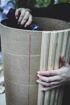 a person holding onto a piece of wood