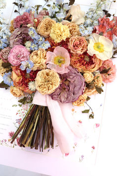 a bouquet of flowers sitting on top of a piece of paper