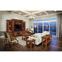 a living room filled with furniture and a flat screen tv on top of a wooden entertainment center